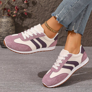 Two-tone suede lace-up sneakers in pink purple with white and dark purple accents.