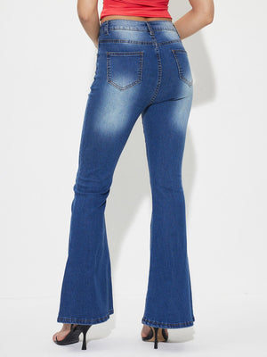 Mid-rise flared denim jeans in medium wash cotton with whiskering detail.