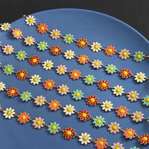Daisy chain enamel collar necklace with gold chain and colorful flower charms.