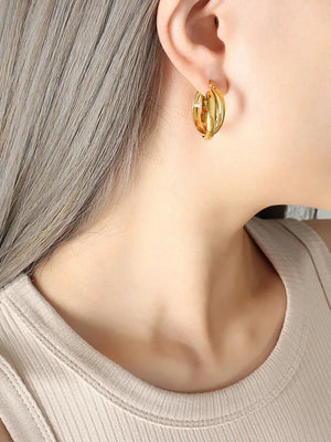 Gold double band hoop earrings with sculpted detail.