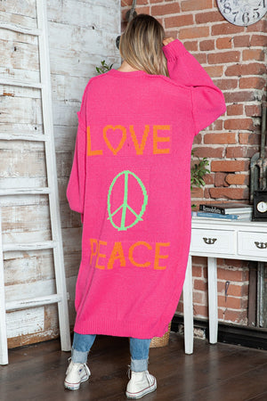 Pink maxi knit cardigan with orange LOVE and peace sign graphic, long sleeves.
