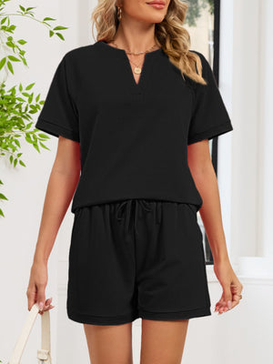 Black loungewear shorts with drawstring waist and cuffed hem.