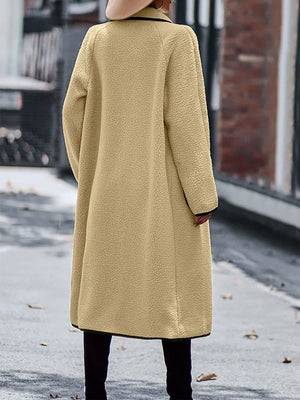Camel teddy coat with black contrast trim detailing, long sleeves, and midi length.