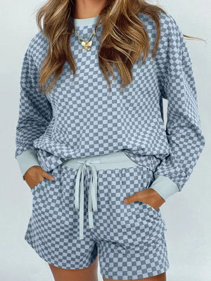 Light blue checkerboard loungewear set with crewneck pullover and drawstring shorts.