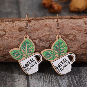 Wooden drop earrings with green leaves and coffee cup graphic, text reads Coffee & Plants