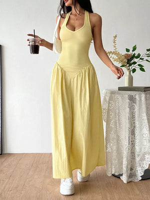 Yellow V-neck ruched maxi dress with empire waist and halter straps.
