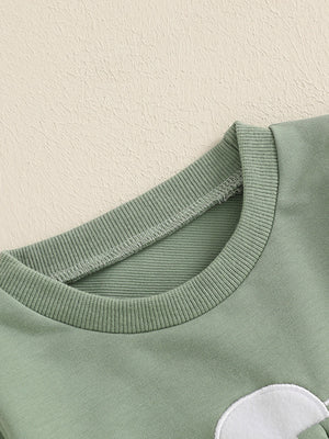 Green cotton baby outfit with bunny applique detail and ribbed crew neck.