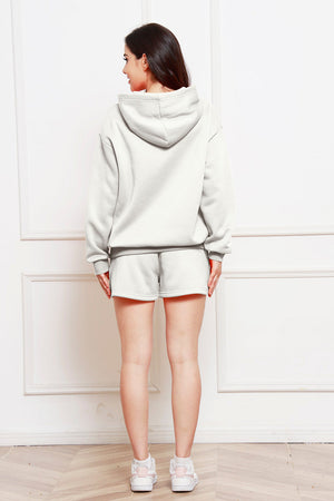 Light gray oversized hoodie and bermuda shorts set with a relaxed fit.