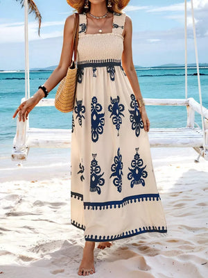 Smocked square neck maxi dress in cream with blue paisley print and ruffle straps.