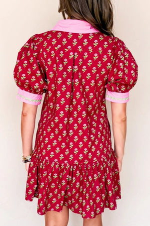 Red floral mini dress with puff sleeves, ruffled hem, and pink collar.