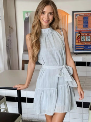 Sky blue mini dress with halter neckline, tie waist, and tiered skirt.