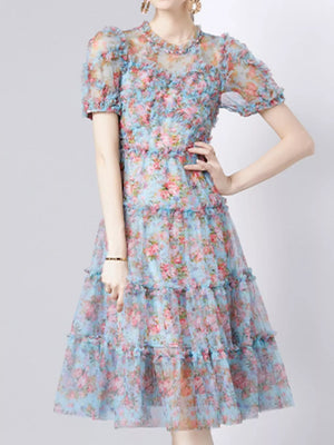 Light blue floral print dress with ruffled short sleeves and tiered skirt.