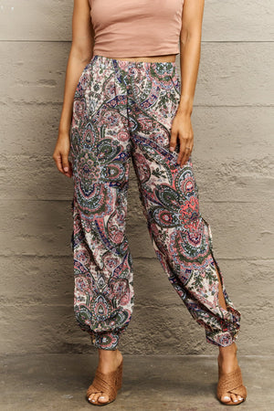 Paisley print joggers in multicolor with slit legs and cuffed ankles.
