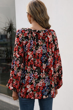 Red floral print blouse with gathered yoke and balloon sleeves.
