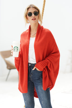 Orange-red acrylic cocoon knit sleeve cardigan with open front and ribbed cuffs.