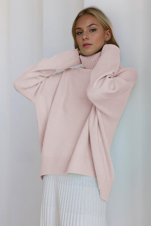 Oversized blush pink cashmere turtleneck sweater with ribbed cuffs and hem.