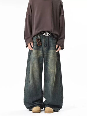 Vintage wash baggy blue cotton jeans with a belted waist and oversized fit.