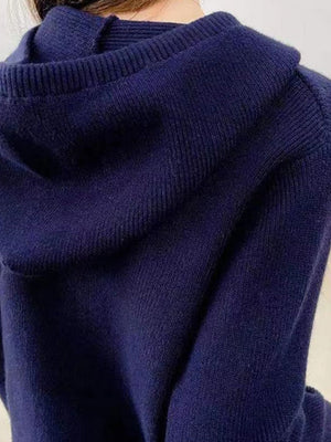 Dark blue ribbed knit zip-through hoodie with a hood and visible texture.