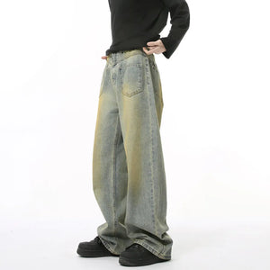 Distressed medium wash wide leg jeans with yellow acid wash details.
