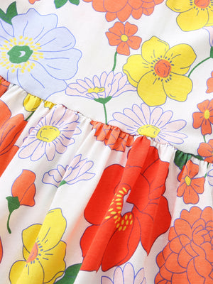 Toddler dress with playful floral print, ruffle detail, and cotton fabric.