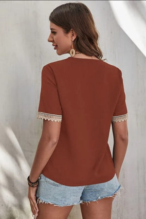 Brown V-neck blouse with lace trim on short sleeves