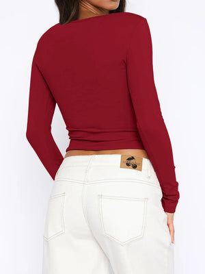 Burgundy ribbed crop top with long sleeves and a button-down front, shown from the back.