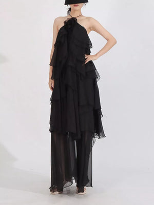 Black cascading ruffle halter maxi dress with sheer wide legs.