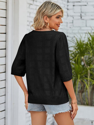 Black openwork box stitch knit top with puff sleeves and crew neck.