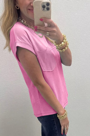 Pink waffled seam pocketed t-shirt with short sleeves and a crew neck.