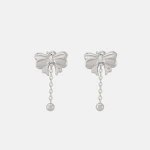 Silver bow drop chain earrings with a ball charm.