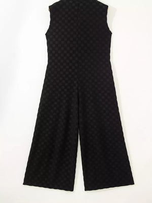 Black checkered wide-leg jumpsuit with a button-front and sleeveless design.