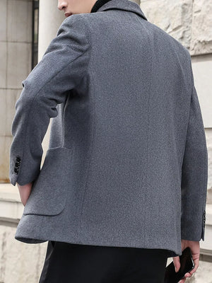 Men's grey lapel collar blazer with buttoned cuffs and flap pockets.
