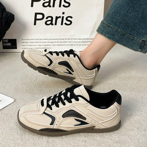 Camel retro runner sneakers with black accents and laces.