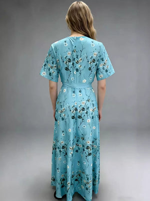 V-neck floral wrap maxi dress in blue with short sleeves and a belted waist.