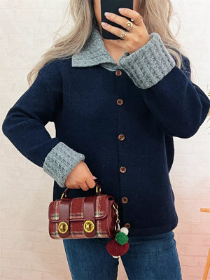 Navy button-down cardigan with textured grey collar and cuffs.
