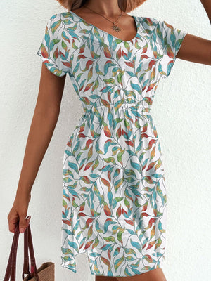Vibrant leaf print mini dress with slit, short sleeves, and a V-neck.