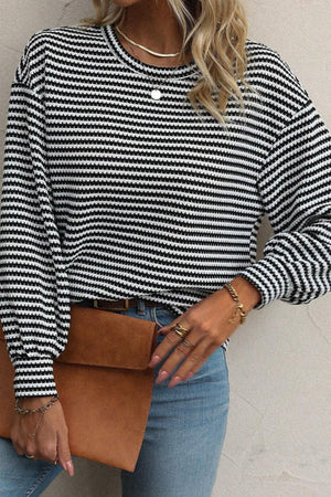 Textured stripe balloon sleeve top in black and white with a crew neck.