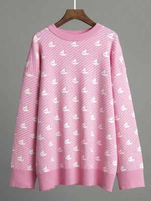 Blush pink knit sweater with allover white sailboat pattern and ribbed crewneck.