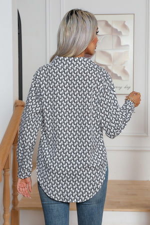 Collared blouse in black and white monogram print with buttoned cuffs.