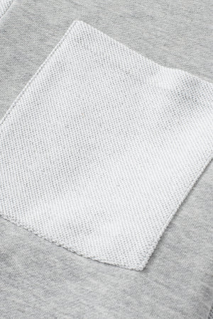 Colorblock sweatshirt in light gray with a contrasting white pocket detail.