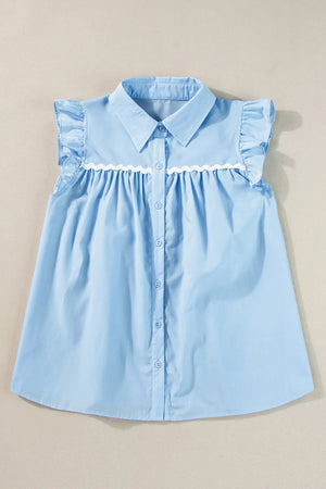 Light blue poplin blouse with ruffled yoke and sleeves, white scalloped trim, and button front.
