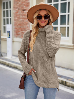 Khaki ribbed turtleneck sweater with side slits, long sleeves, and a relaxed fit.