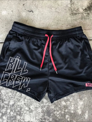 Black mesh athletic shorts with white Kill Crew graphic and neon pink drawstrings.