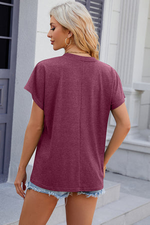 Dolman sleeve slouchy v-neck top in red-violet with a casual fit.