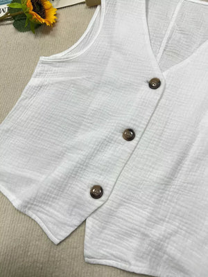 White textured vest with tortoiseshell buttons and V-neck