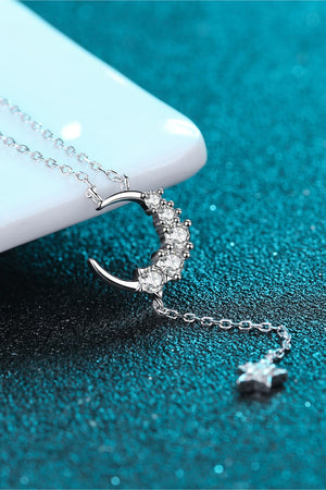 Silver celestial crescent moon pendant necklace with moissanite accents and a star charm.