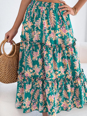 Green floral midi skirt with ruffle hem and tiered design.