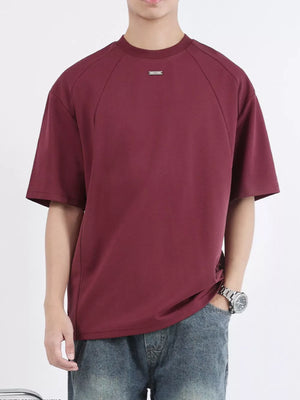 Men's dark purple cotton t-shirt with round neck and subtle metal detail.