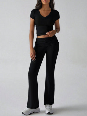 Black ribbed flare leg lounge set with ruched waistband and v-neck crop top.