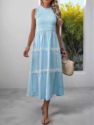 Blue striped sleeveless midi dress with smocked bodice and lace trim tiers.